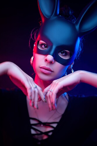 beautiful-girl-bodysuit-poses-photo-studio-dark-background-neon-light-face-rabbit-mask